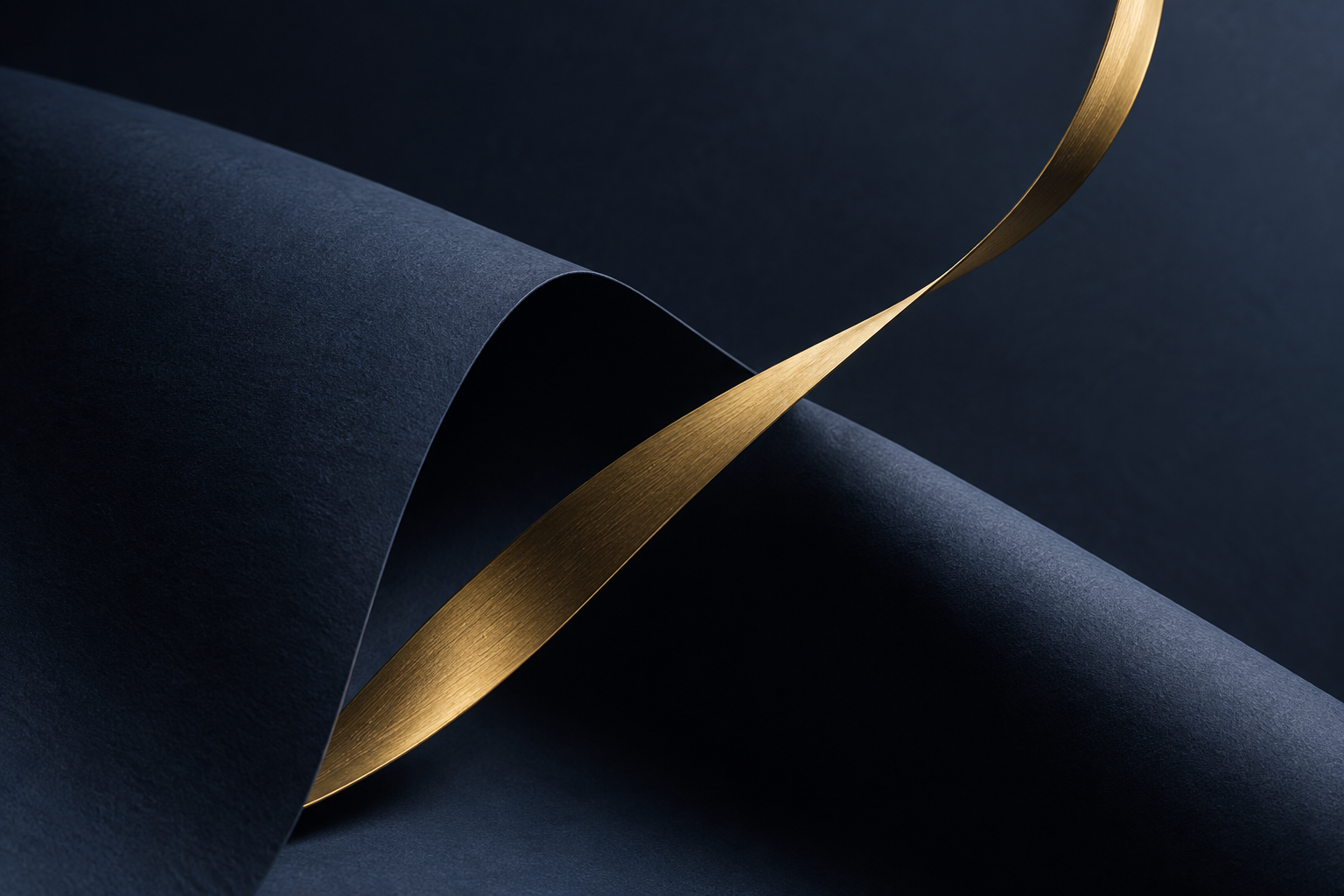 Sculptural navy paper with a sweeping gold ribbon
